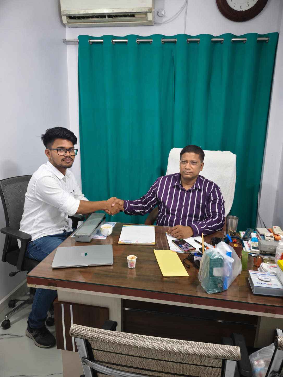 An Inook AI team member shaking hands with a business owner at his office